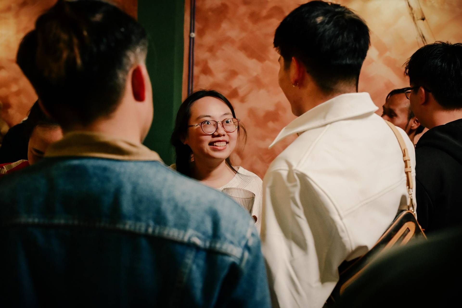 A lively gathering in Đà Lạt, Vietnam, where friends engage in animated conversation amidst a warm and inviting atmosphere.
