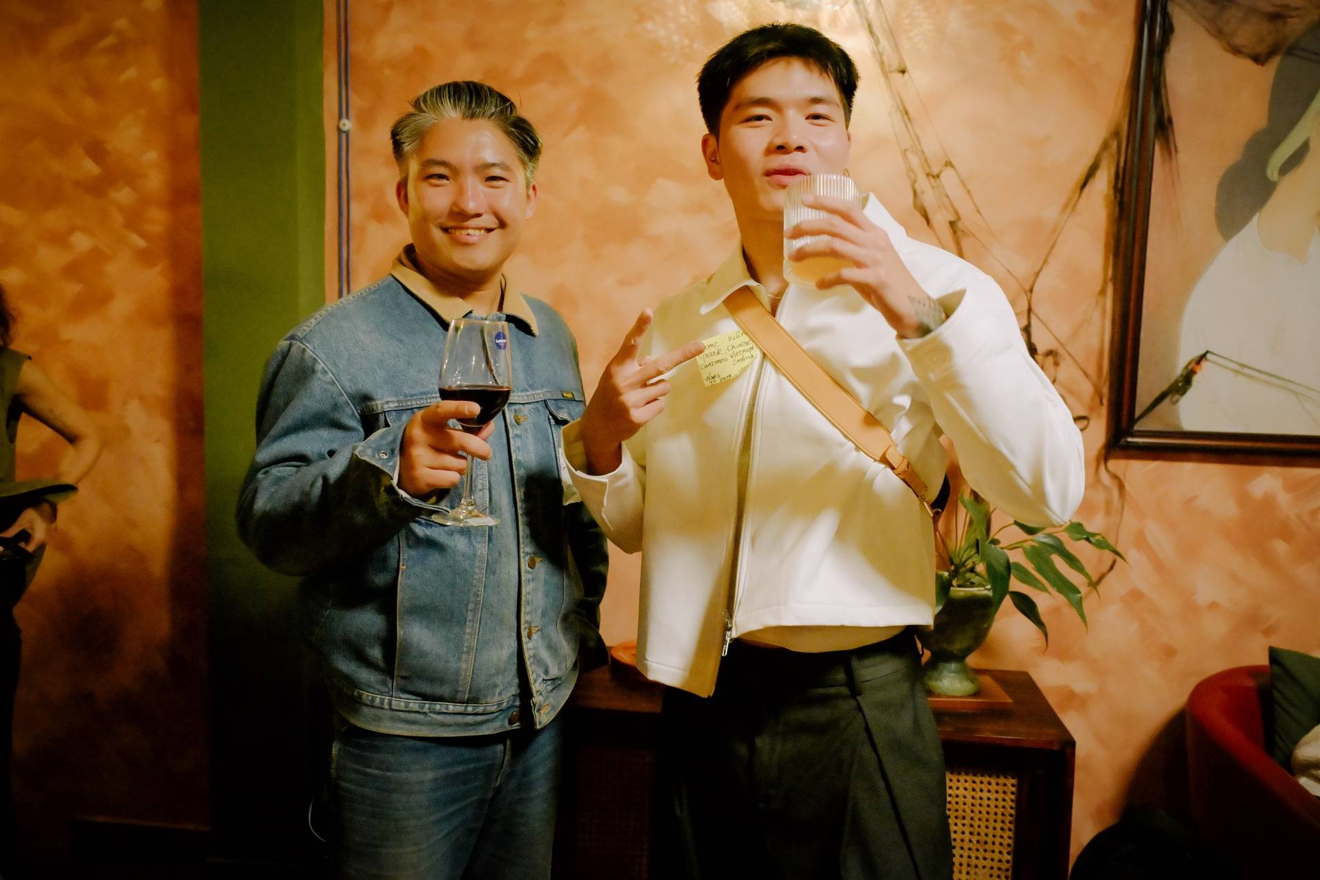Two individuals enjoying drinks in a cozy café setting in Đà Lạt, Vietnam, with warm lighting and a relaxed atmosphere.