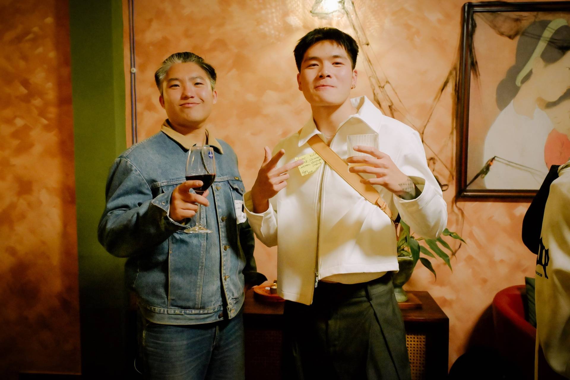 Two individuals enjoying a social gathering in Đà Lạt, Vietnam, holding drinks and engaging with each other in a warm, intimate setting.