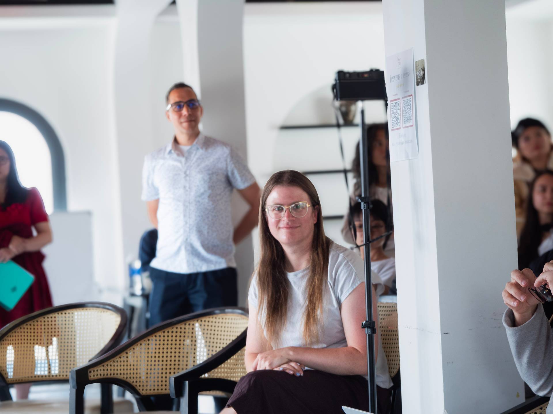 A speaker addressing an audience at a modern tech event in Đà Lạt, with contemporary interior design and bright open space.