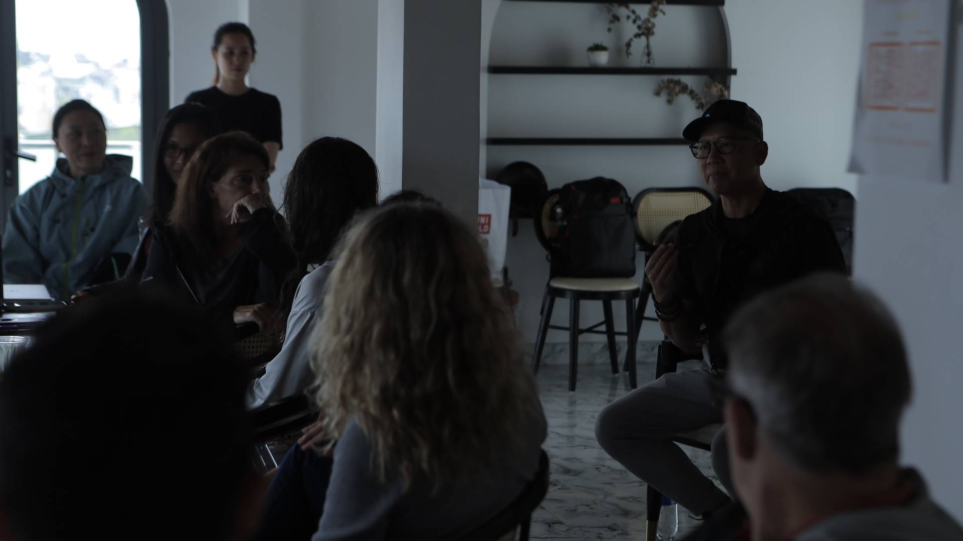 A group of people is engaged in a discussion or presentation within a modern indoor setting in Đà Lạt, Vietnam.