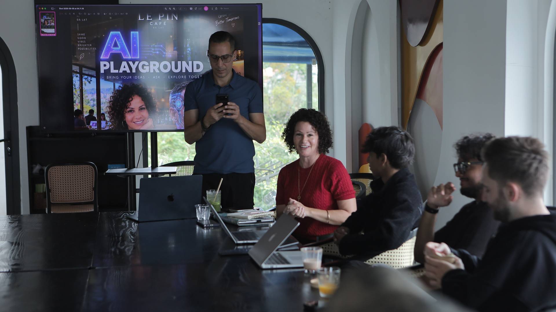 A group of people engaged in a collaborative meeting or workshop session in Đà Lạt, Vietnam, with a focus on AI technology and innovation.