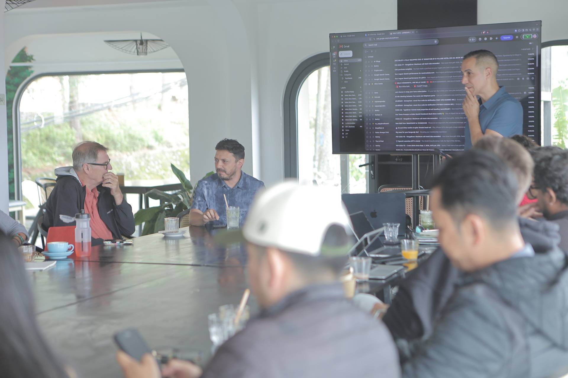 A professional meeting in Đà Lạt, Vietnam, with participants engaged in discussion around a large table under natural light.