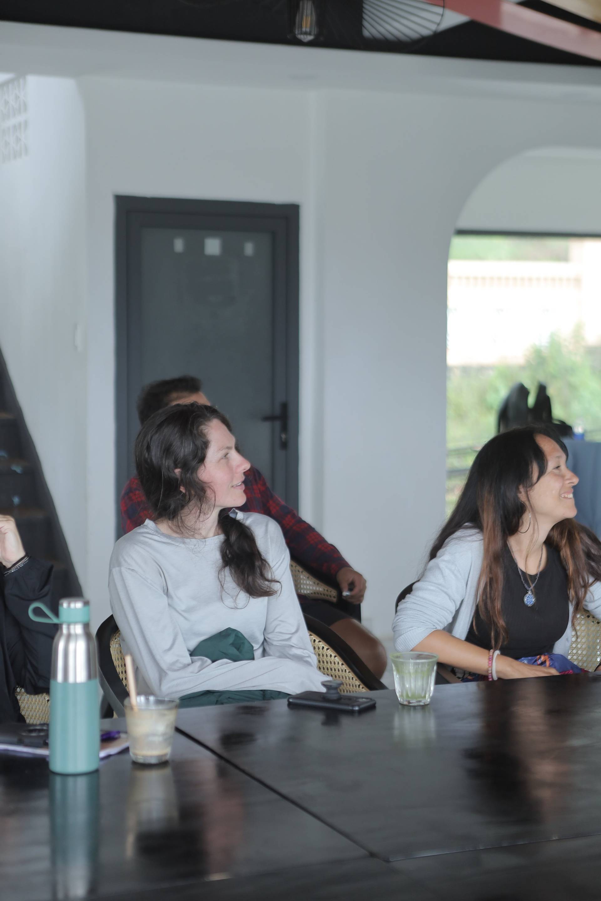 A group of people enjoying a casual gathering in Đà Lạt, Vietnam, with laughter and conversation filling the air.