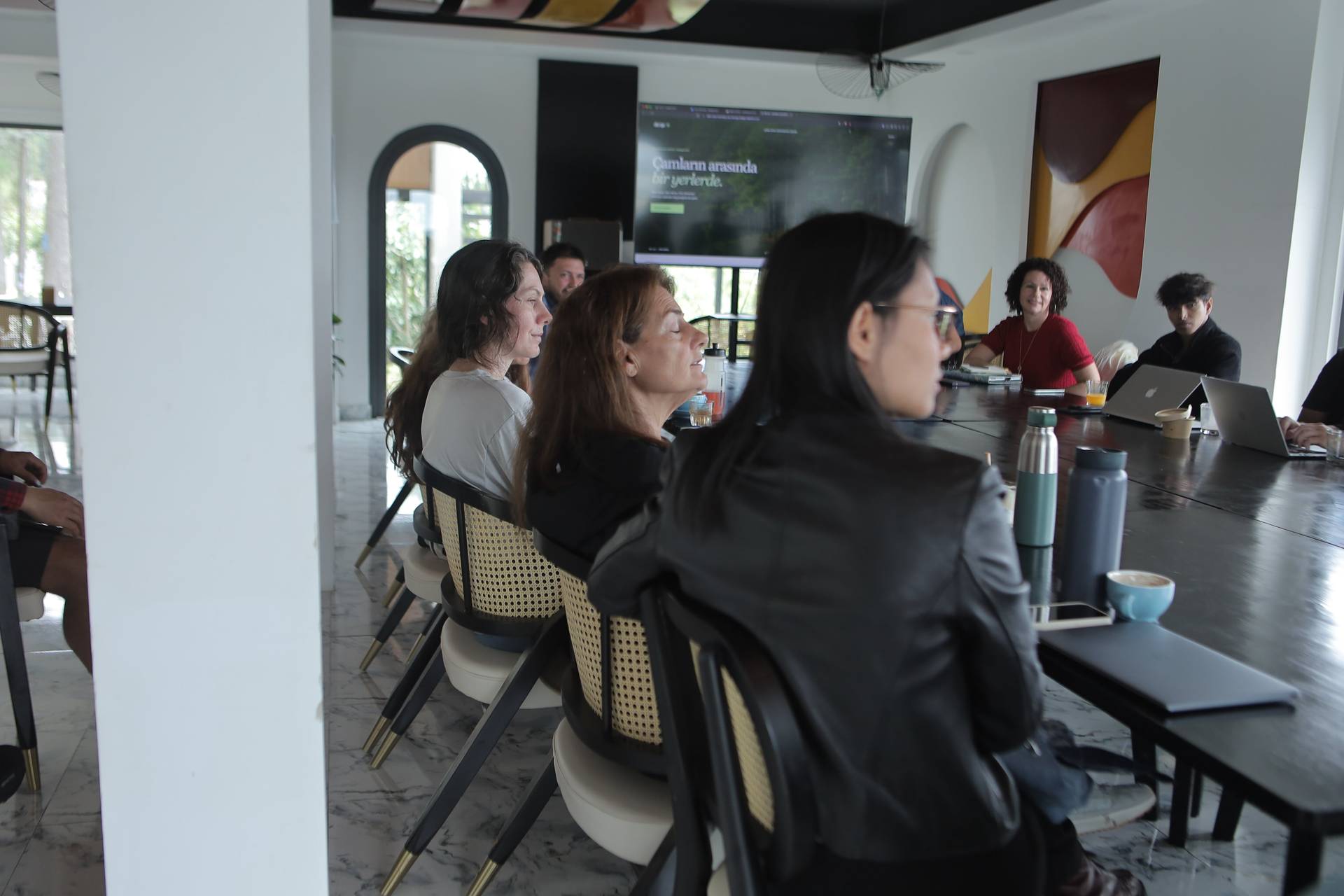 A group of professionals engaged in a collaborative meeting within a modern office space in Đà Lạt, Vietnam.
