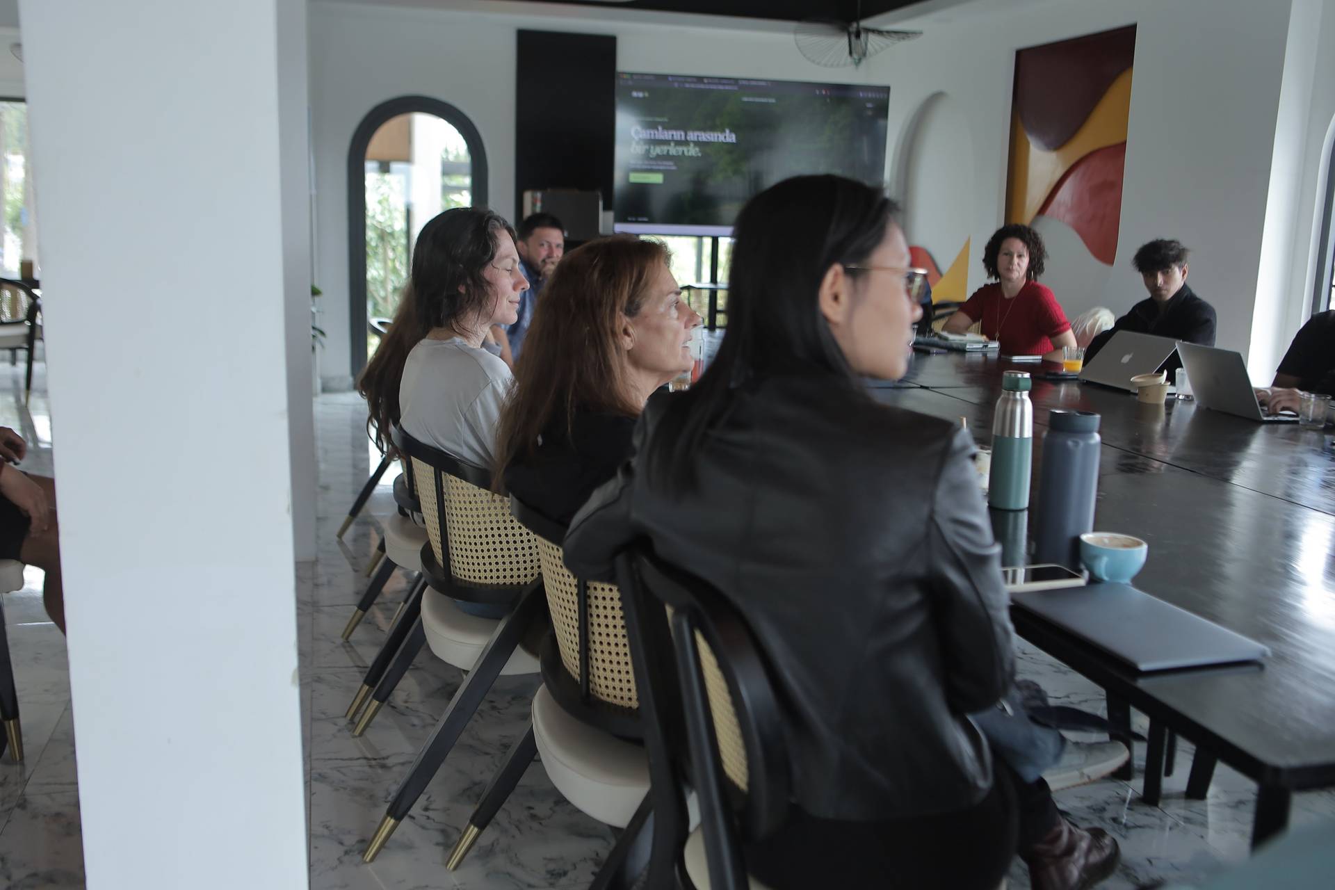 A group of professionals engaged in a collaborative meeting within a modern office space in Đà Lạt, Vietnam.