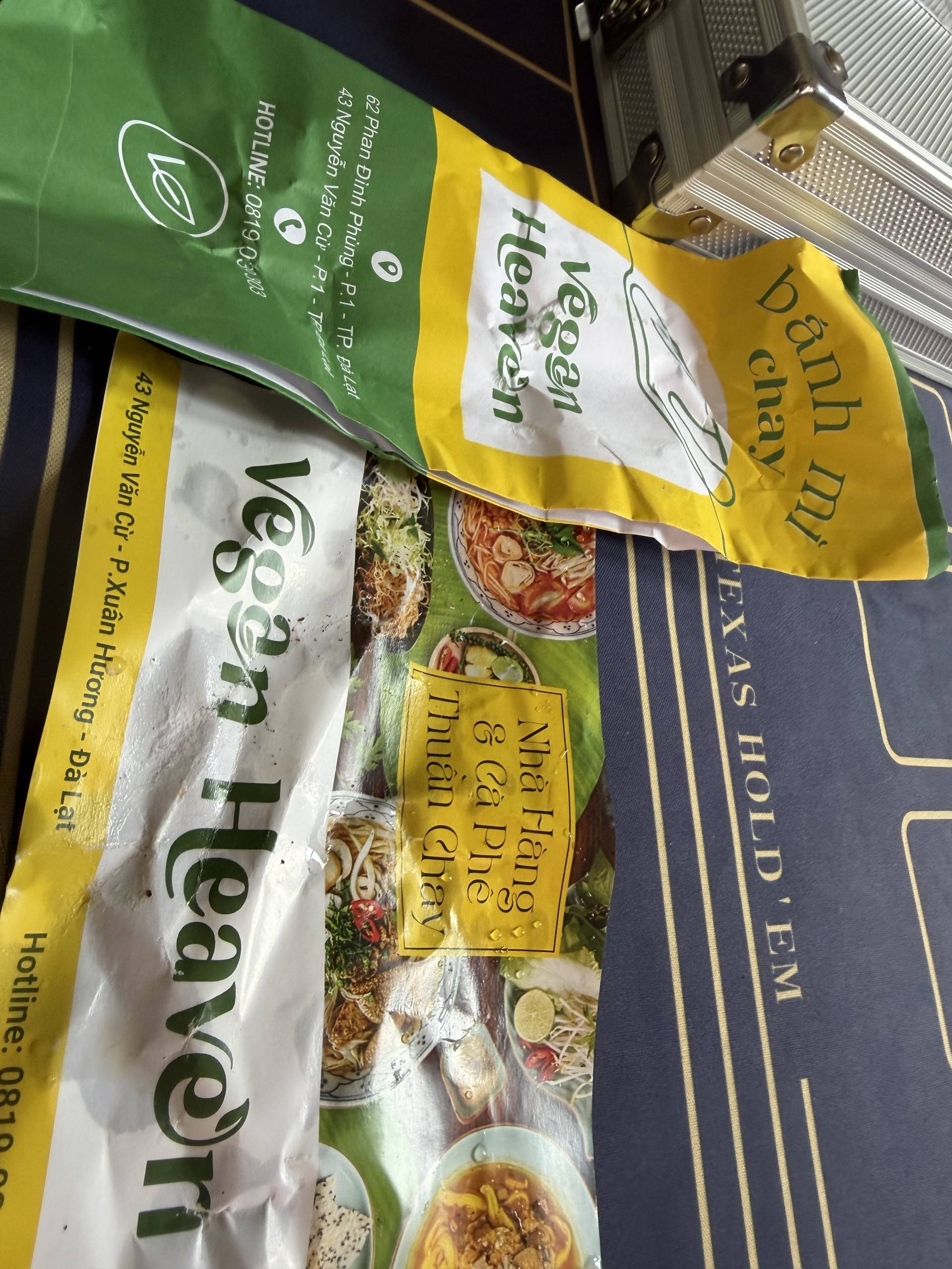 Vietnamese instant noodle product packaging displayed, featuring vibrant yellow and green branding with product imagery of prepared hot pot-style noodles for Vietnamese cuisine.