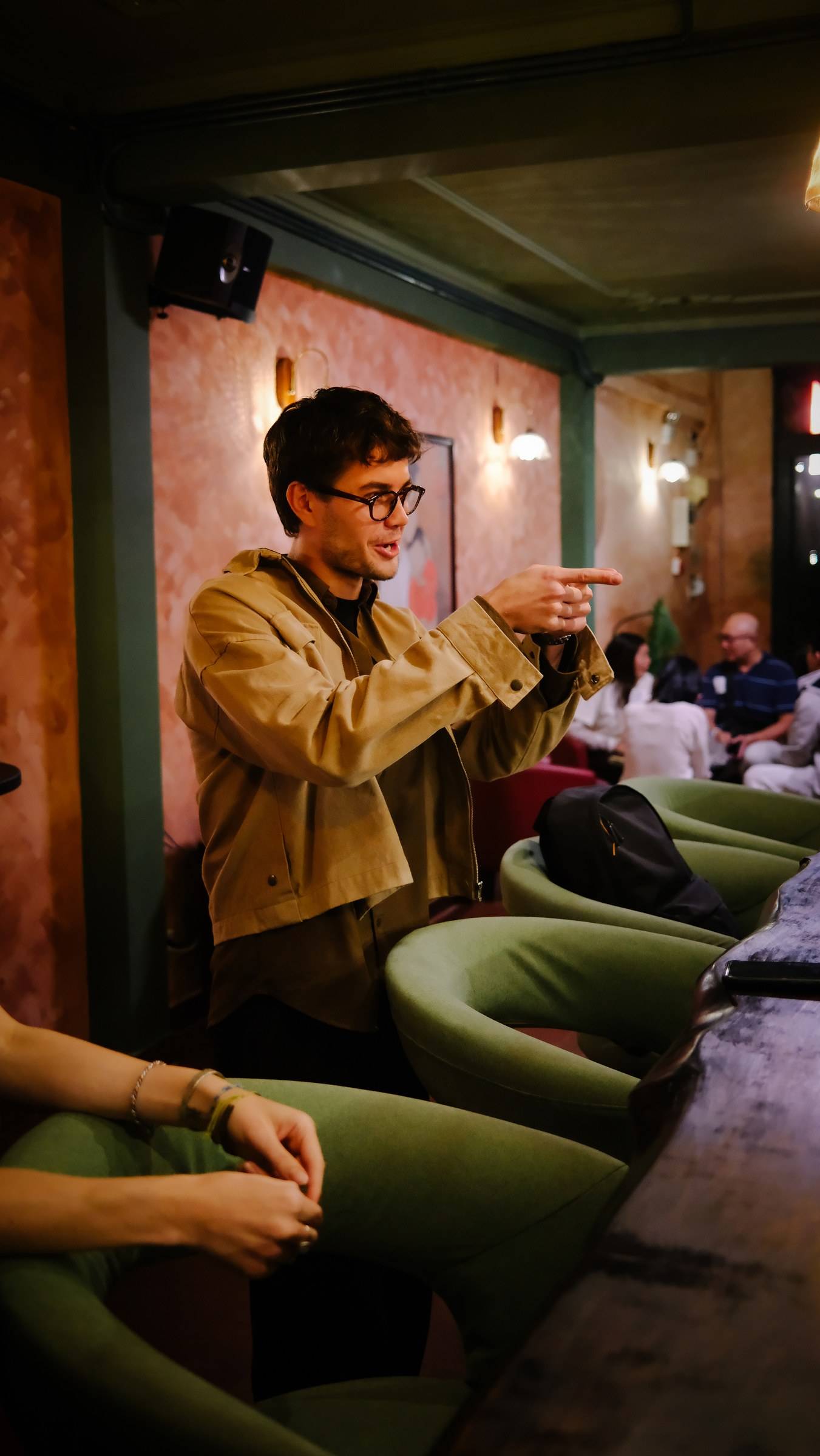 A lively discussion unfolds in a cozy café setting in Đà Lạt, Vietnam, with attendees engaged and animated gestures.