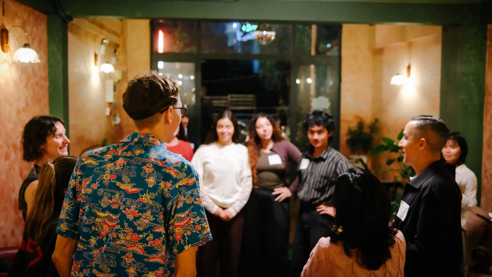 A lively gathering of friends in Đà Lạt, Vietnam, with a vibrant atmosphere and warm lighting creating a cozy ambiance.