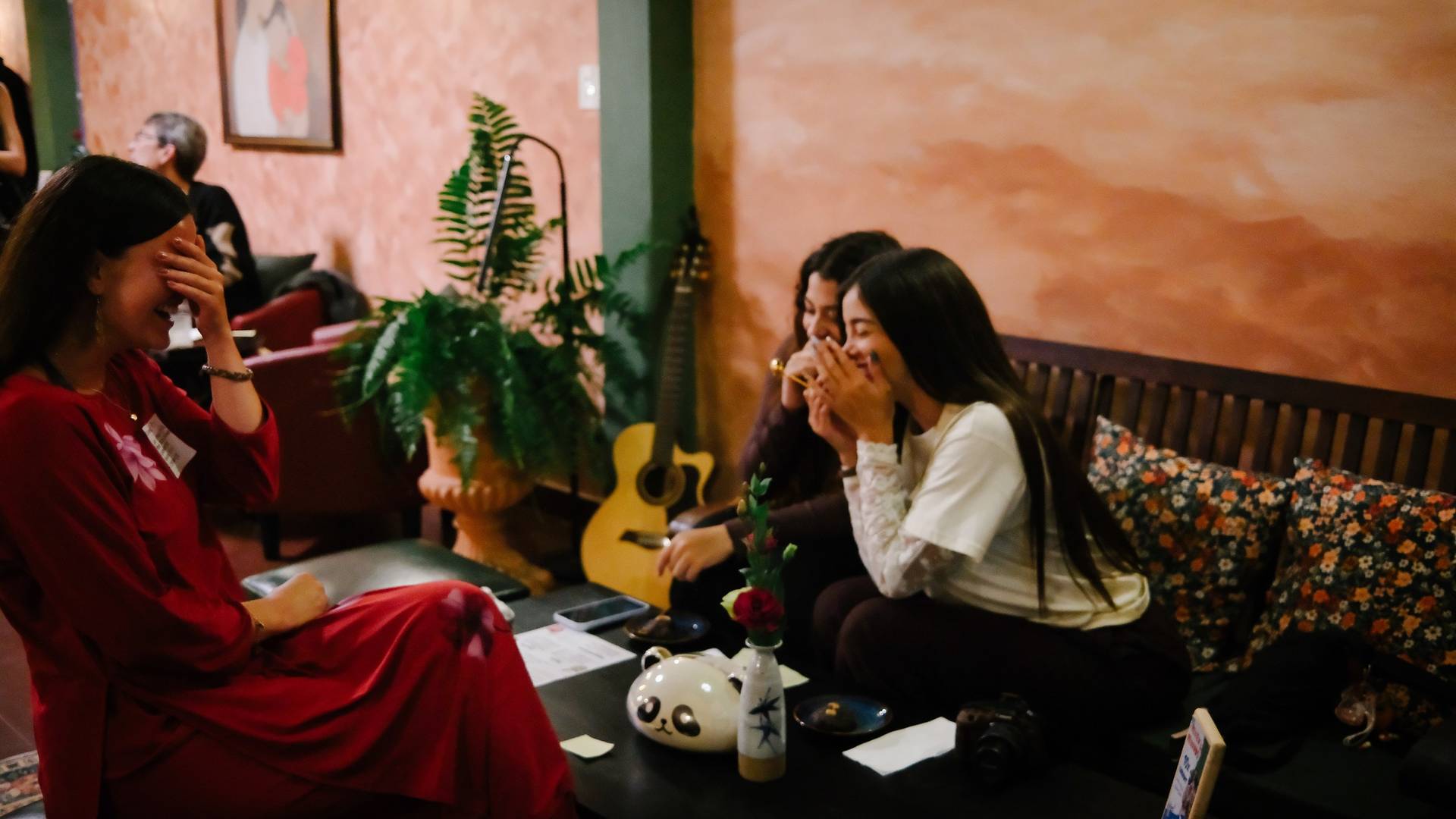 Friends gather in a cozy café in Đà Lạt, Vietnam, sharing laughter and enjoying each other's company over casual conversation.