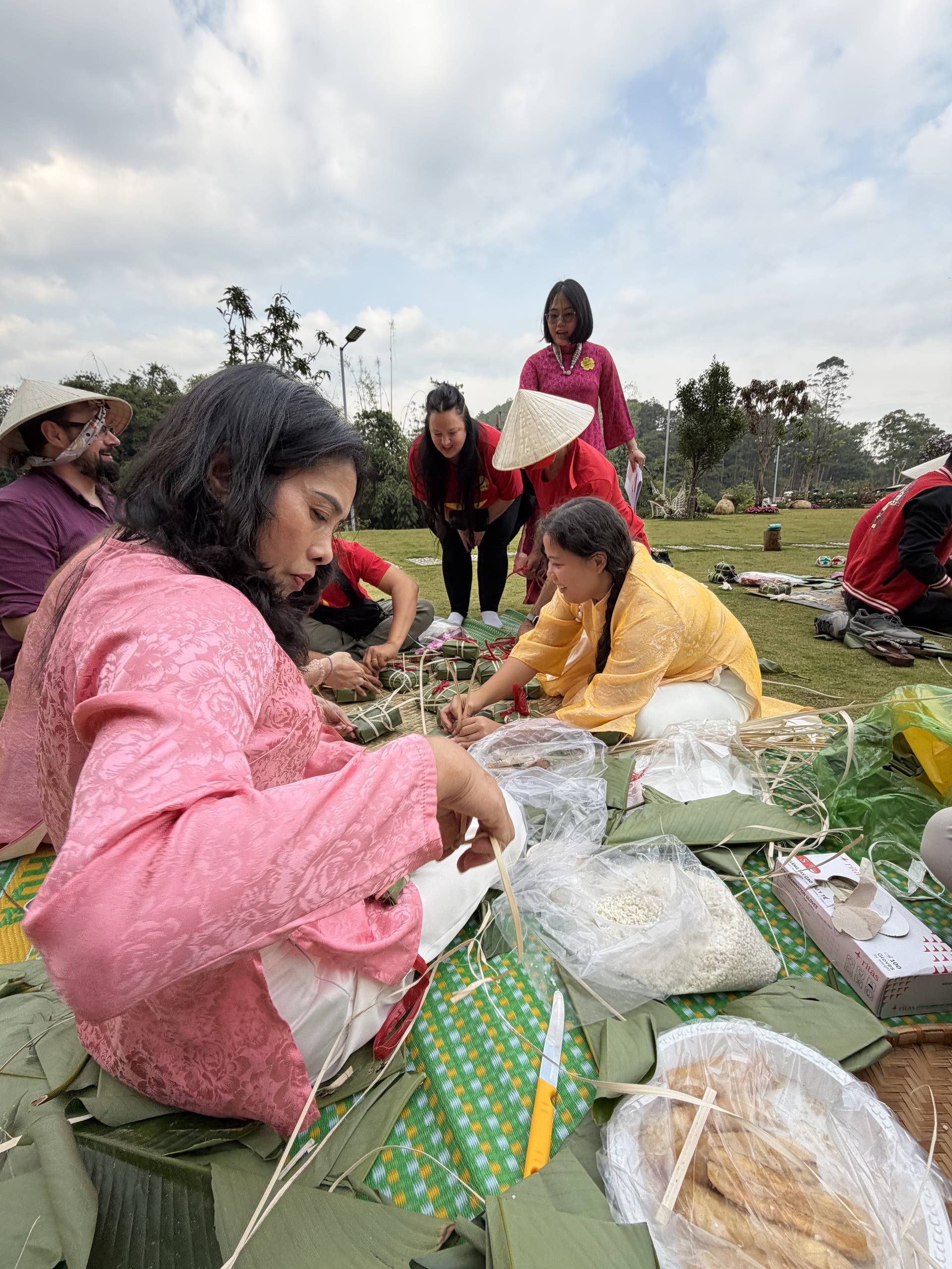 Traditional Tết celebration at a heritage venue in Đà Lạt showcasing bamboo steamers, festive decorations, and cultural food crafts. Historic architecture with red lanterns creates authentic lunar new year ambiance with interactive food preparation.