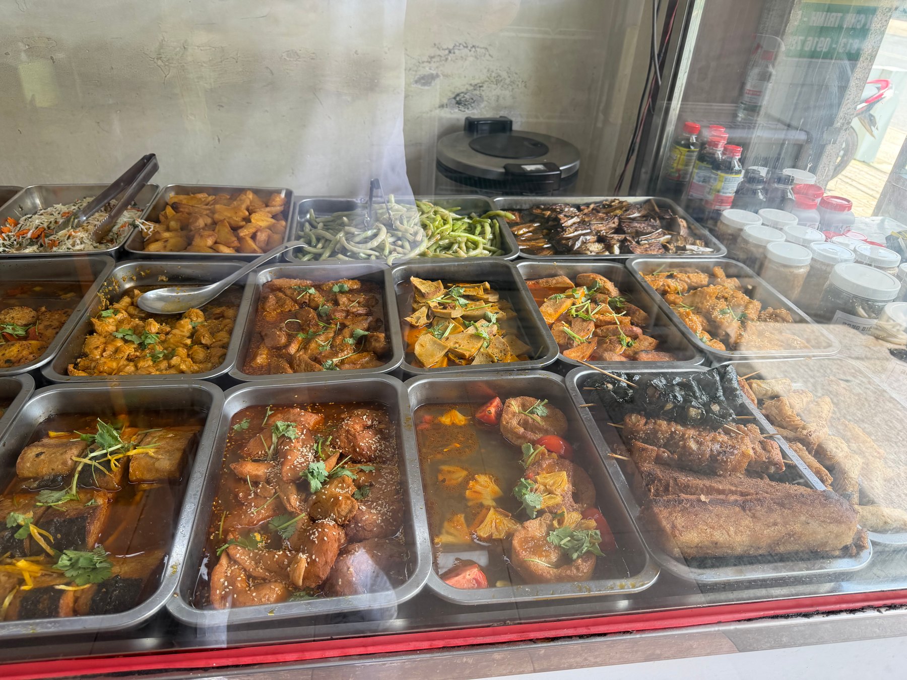 A wider view of the buffet spread with many different dishes