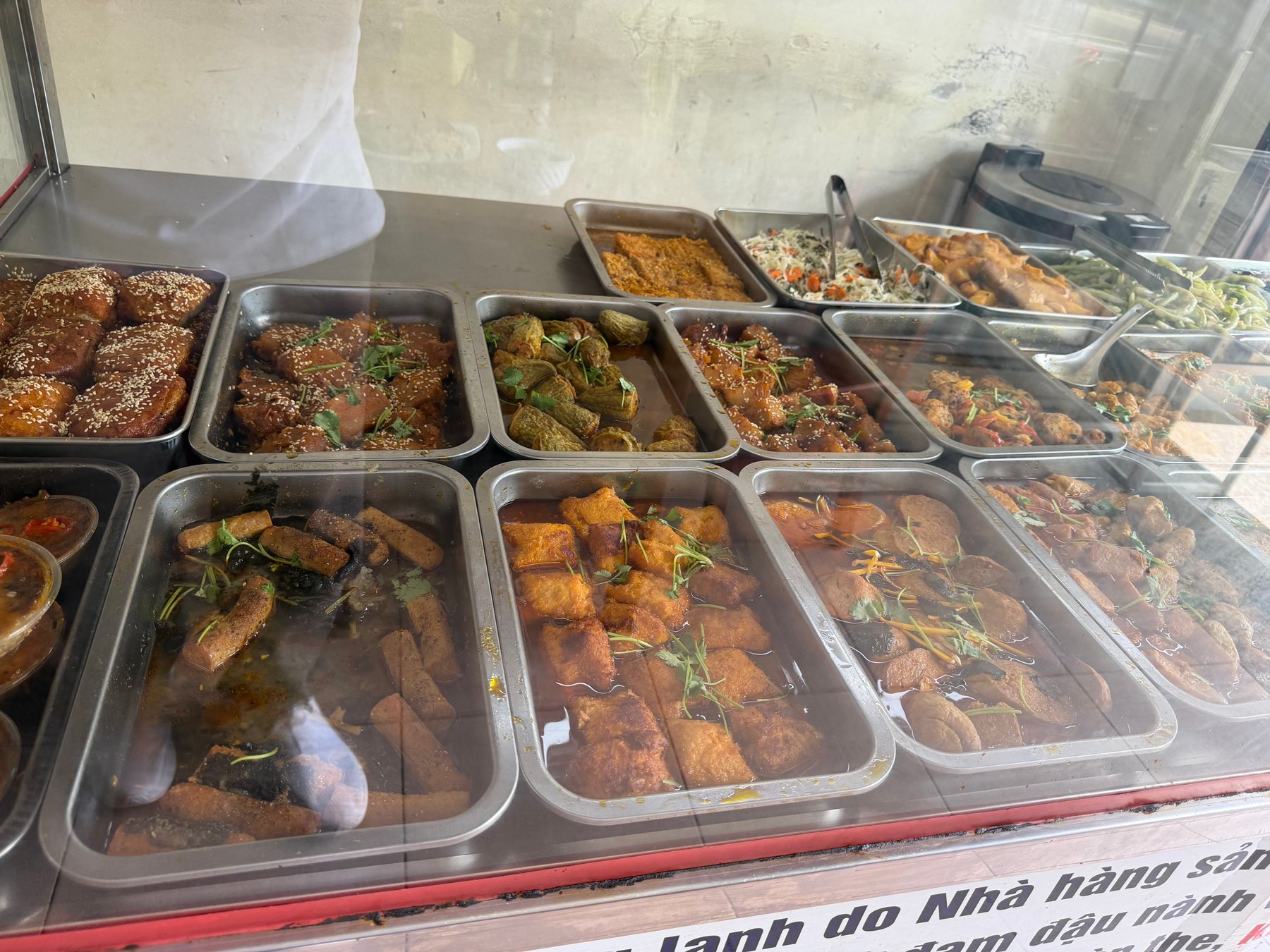 A display of various vegetarian dishes in metal trays